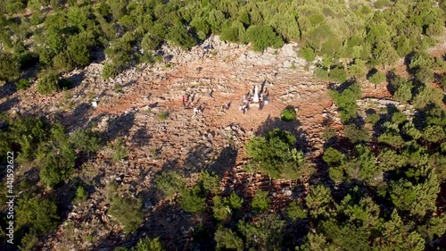 Aerial drone view of Apparition hill in Medjogorje, Bosnia and Herzegovina. Worn Path to a religious pilgrimage. Međugorje. photo