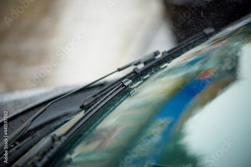 Close-up car windshield wiper in the rain.