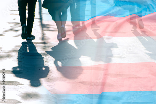 Transgender flag, shadows and silhouettes of people on a road, conceptual picture about anonymous Transgender and Gay Lesbian in the World photo