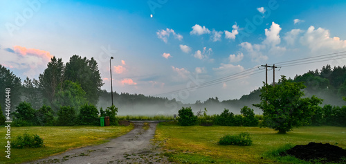 late evening sky mist and lawn in june photo