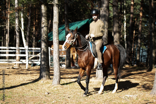 Young Man Rides a Horse Wearing a Helmet