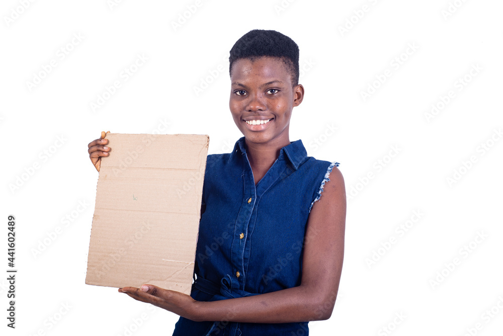 closeup of a girl presenting piece of cardboard, smiling. closeup of a girl presenting piece of cardboard, smiling.