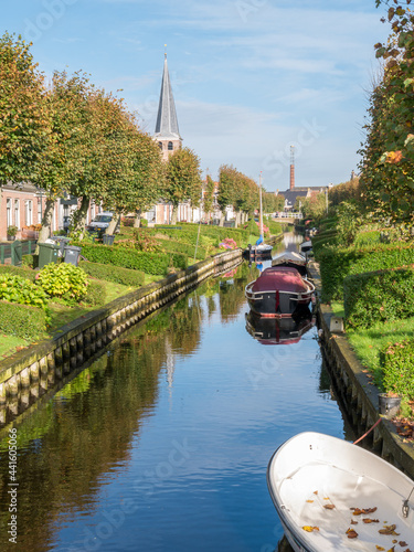 Houses with waterside gardens on Eegracht canal in IJlst, Friesland, Netherlands photo