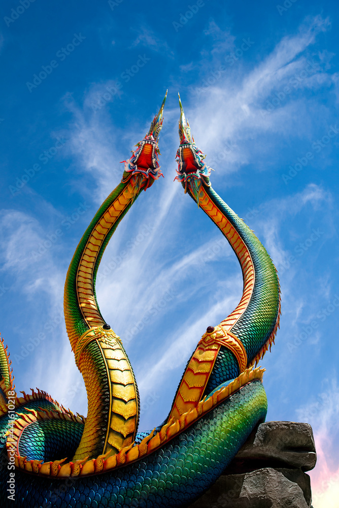 Fototapeta premium Low angle view of Twin Stucco painted as a large serpent with beautiful sky
