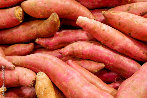 Fresh sweet potato piled on the market. Food background. Harvest