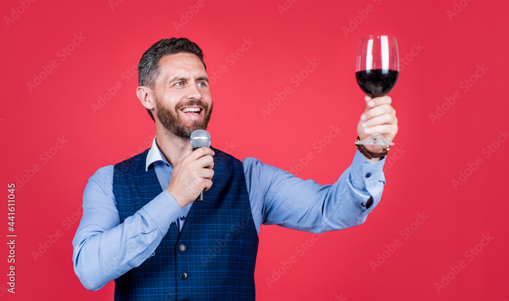 Happy man toastmaster raise glass of wine to propose toast before drinking red background, cheers Happy man toastmaster raise glass of wine to propose toast before drinking red background, cheers