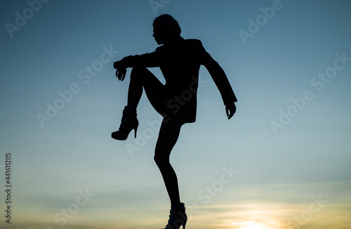 Feel the body. Dancing silhouette. Woman silhouette on evening sky. Dance girl