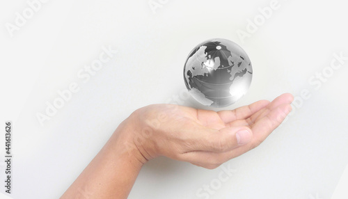 Glass globe in hand Energy saving concept  by NASA