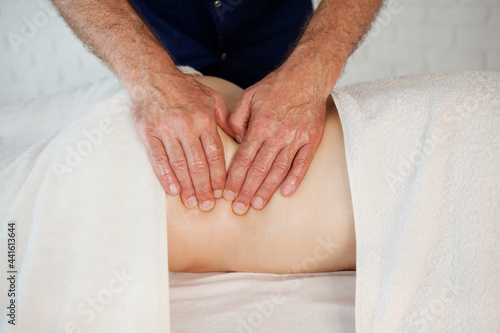 Hands of doctor masseur chiropractor pushing on back points and making acupressure treatment for woman patient. Beauty treatment, massage bodycare in medical clinic from professional