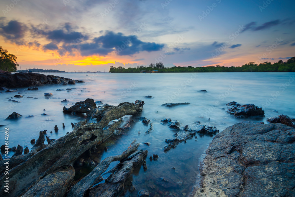 Amazing sunset in Dangas  beach, Batam island, stone on beach