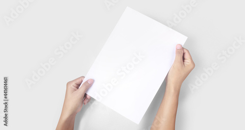 Hands holding paper blank for letter paper