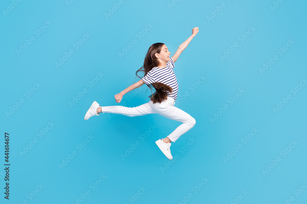 Full body profile side photo of young girl jump up go walk run fast look empty space isolated over blue color background