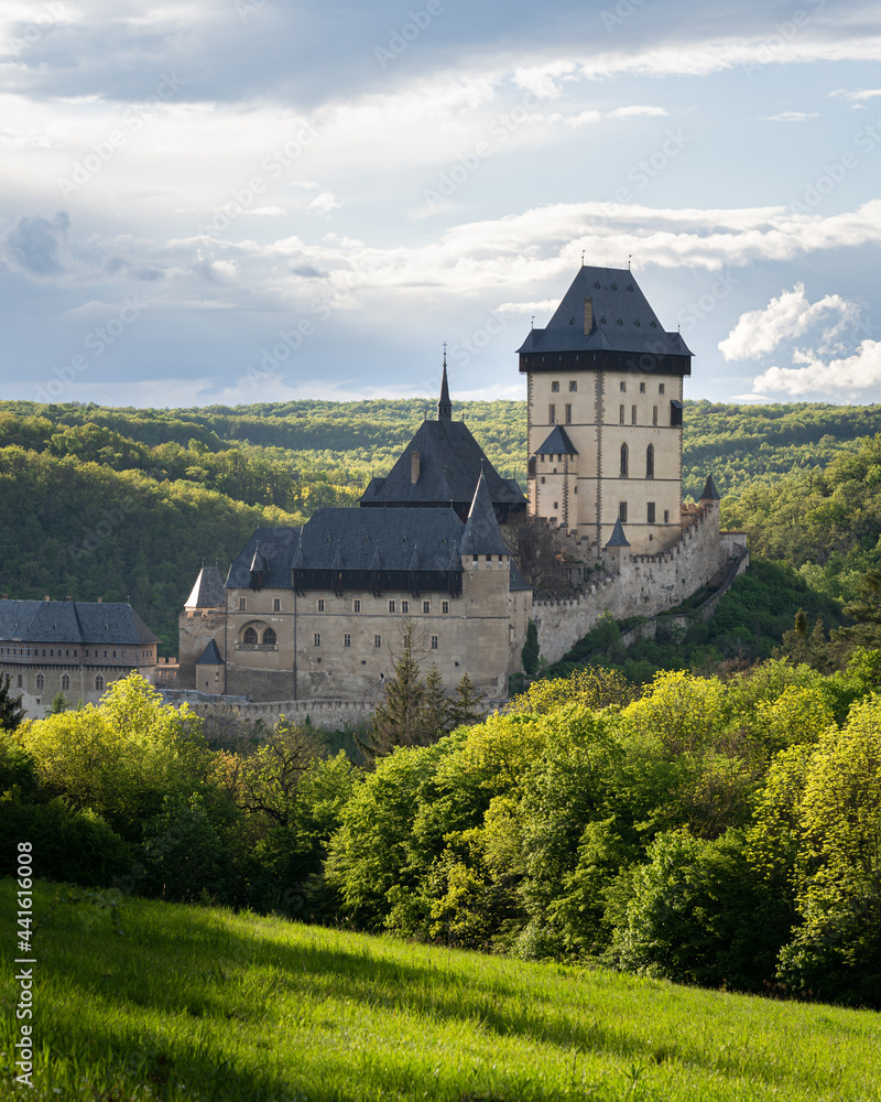 Karlštejn castle in Central Bohemia, Czech Republic at sunset. Beautiful gothic medieval castle surrounded by hills and forests. Popular tourist destination Karlštejn castle in Central Bohemia, Czech Republic at sunset. Beautiful gothic medieval castle surrounded by hills and forests. Popular tourist destination