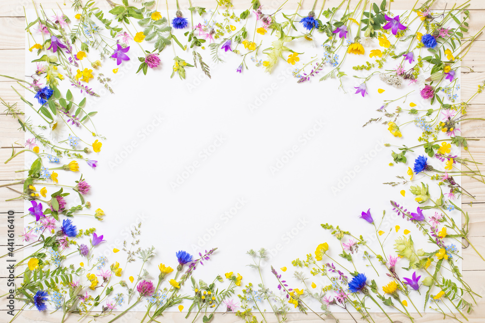 beautiful wild flowers on white sheet on wooden background beautiful wild flowers on white sheet on wooden background