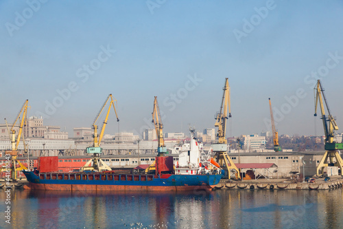 Seaport with cranes and moored dry cargo ship in Constanta Romania. Shipyard in Romania.
