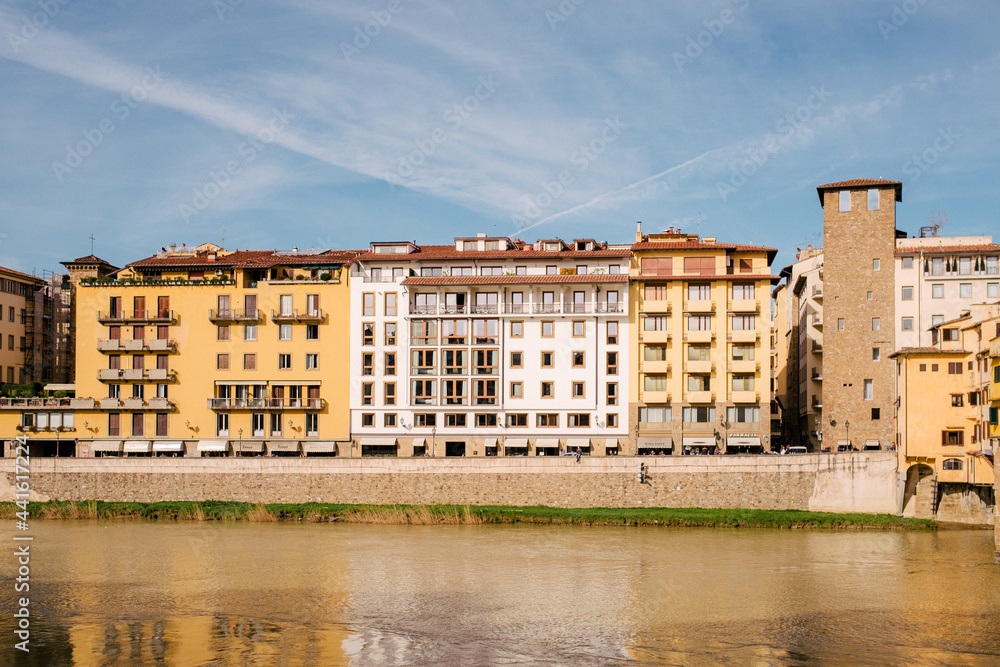 River Arno and houses near bridge Ponte Vecchio in the sunny morning in Florence, Tuscany, Italy
