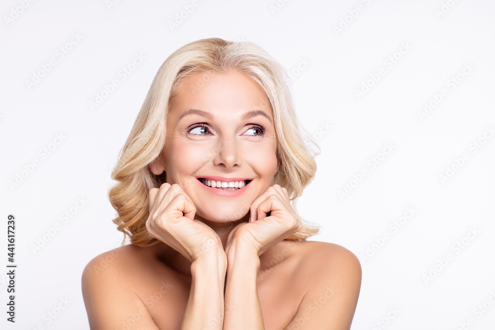 Photo of lovely blond hairdo elder lady hands chin look empty space without clothes isolated on white color background Photo of lovely blond hairdo elder lady hands chin look empty space without clothes isolated on white color background