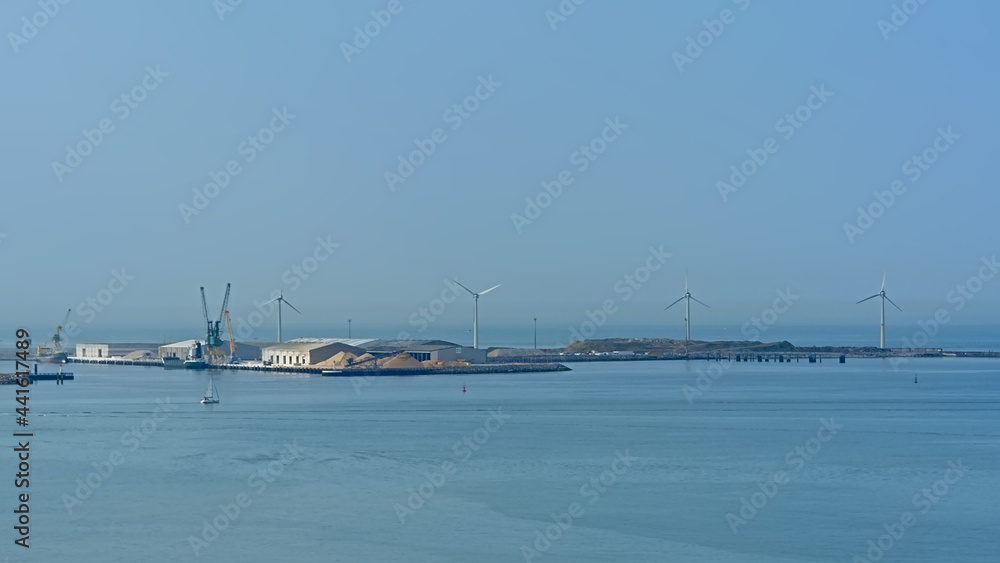 Industrial sea harbor of Boulogne sur mer, Oise, France, with windmills and hangars Industrial sea harbor of Boulogne sur mer, Oise, France, with windmills and hangars