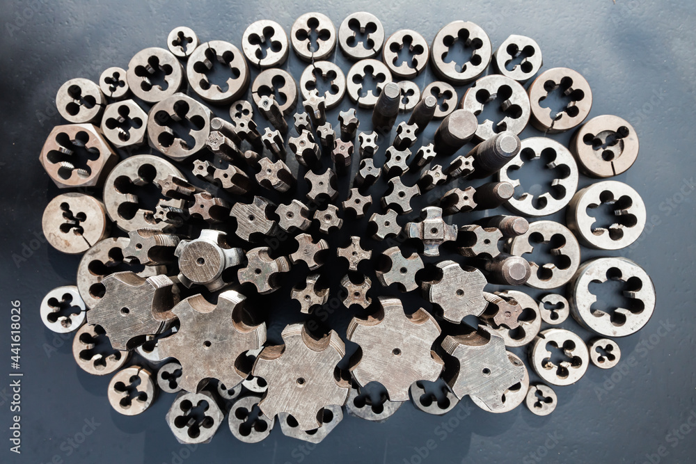 Taps and dies for metal threading. Tools for cutting external and internal threads, closeup