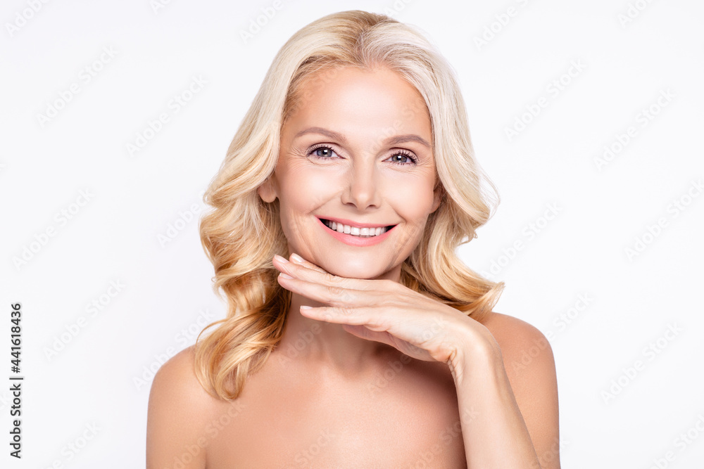 Photo of aged woman happy positive smile hand touch chin plastic lifting cosmetology isolated over grey color background Photo of aged woman happy positive smile hand touch chin plastic lifting cosmetology isolated over grey color background