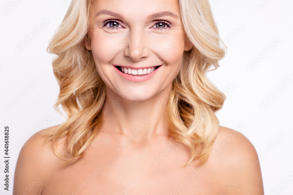 Cropped photo of senior woman happy positive toothy smile perfect clean skin isolated over grey color background Cropped photo of senior woman happy positive toothy smile perfect clean skin isolated over grey color background