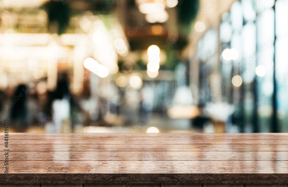 Empty wooden table top with lights bokeh on blur restaurant background