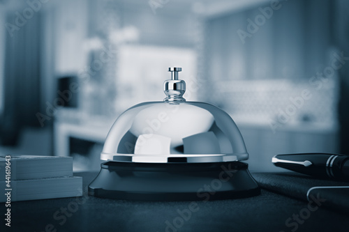 Reception Ring Alarm Service Bell on a Table in Blue Key. 3d Rendering