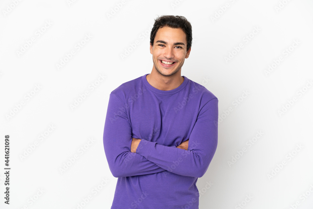Caucasian handsome man over isolated white background keeping the arms crossed in frontal position Caucasian handsome man over isolated white background keeping the arms crossed in frontal position