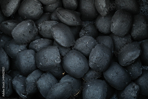 Close-up of an oval-shaped unburned charcoal grill