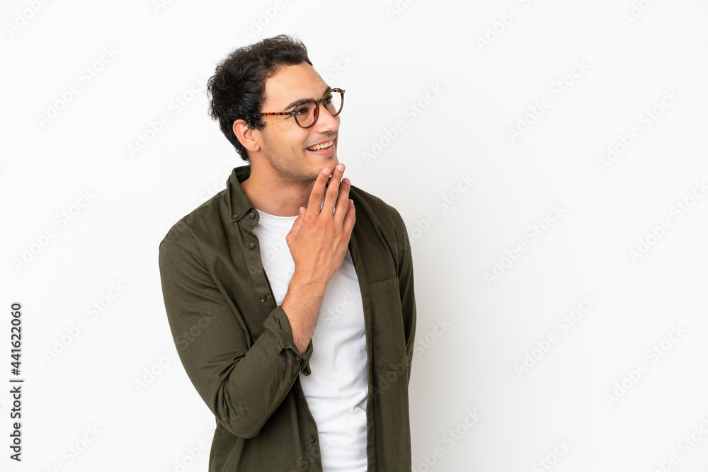 Caucasian handsome man over isolated white background looking up while smiling Caucasian handsome man over isolated white background looking up while smiling