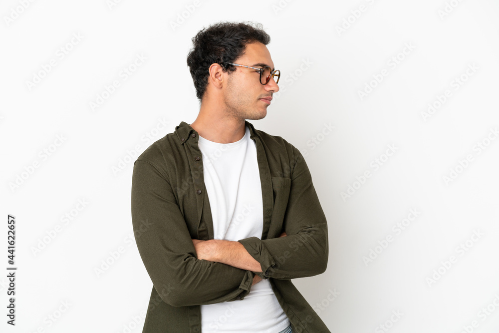 Caucasian handsome man over isolated white background keeping the arms crossed Caucasian handsome man over isolated white background keeping the arms crossed