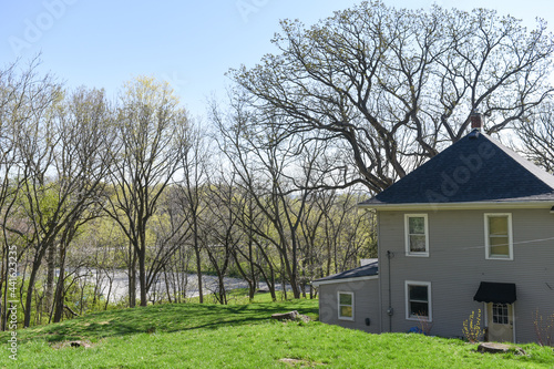 Gray farmhouse with oak trees