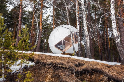 The house has an unusual round shape. Western Siberia