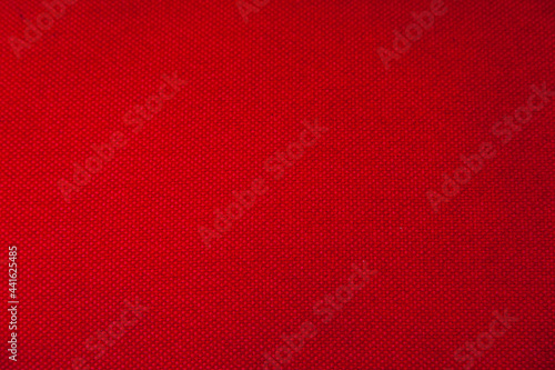 Texture of red cotton fabric closeup. Red textile background.
