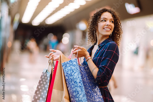 Shopping time. Young woman after shopping in the mall. Consumerism, sale, purchases, lifestyle concept.