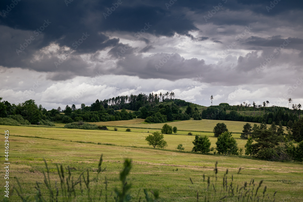 Empty field with hills and heavy clouds on background - Czech Republic - Czechia, Europe