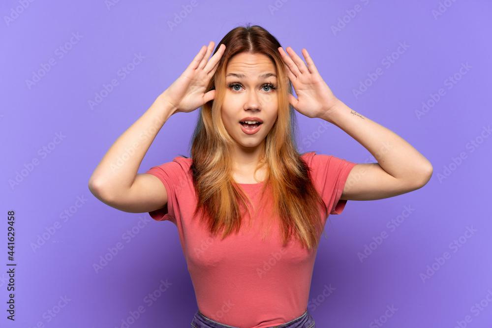 Teenager girl over isolated purple background with surprise expression Teenager girl over isolated purple background with surprise expression