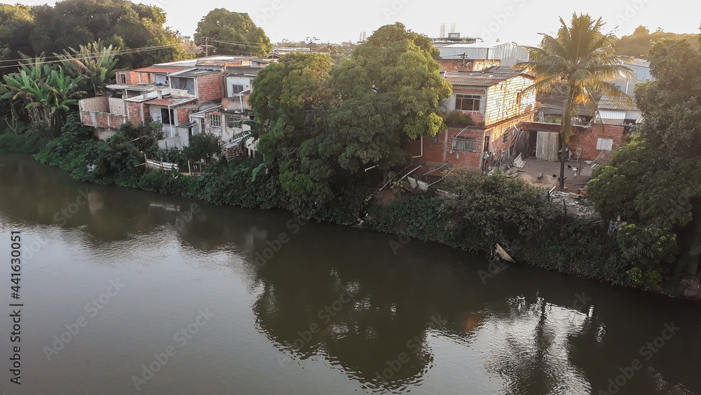 Mighty Paraiba do Sul river in Volta Redonda, Rio de Janeiro, Brazil. houses on the banks of the polluted river.