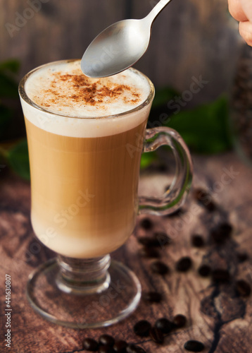  cup of cappuccino coffee with foam on rustic background