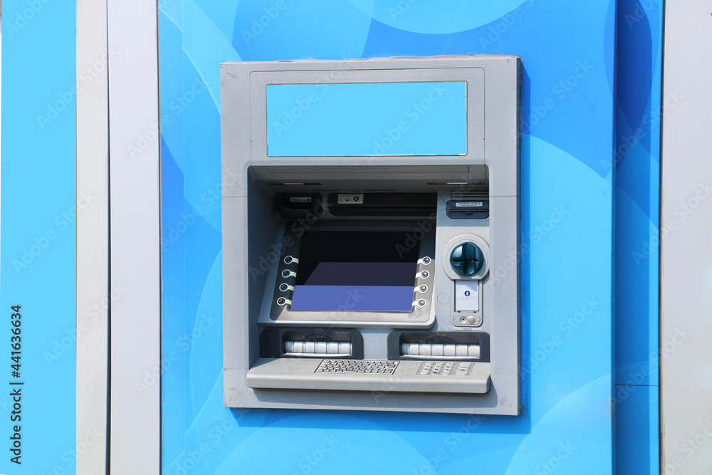 ATM. automatic money and deposit machine. wall mounted automatic teller machine in blue color ATM. automatic money and deposit machine. wall mounted automatic teller machine in blue color