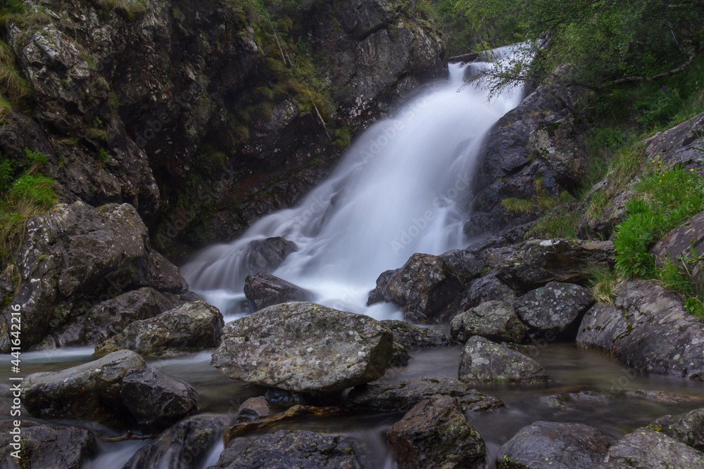 Fototapeta premium beautiful mountain waterfall with big stones and lots of water