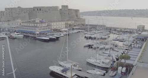 Aerial Drone footage view of Castle Dell’Ovo in Naples Italy seaport sea evening  // no video editing
 photo