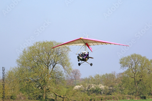 Canvas-taulu Ultralight airplane flying in a blue sky