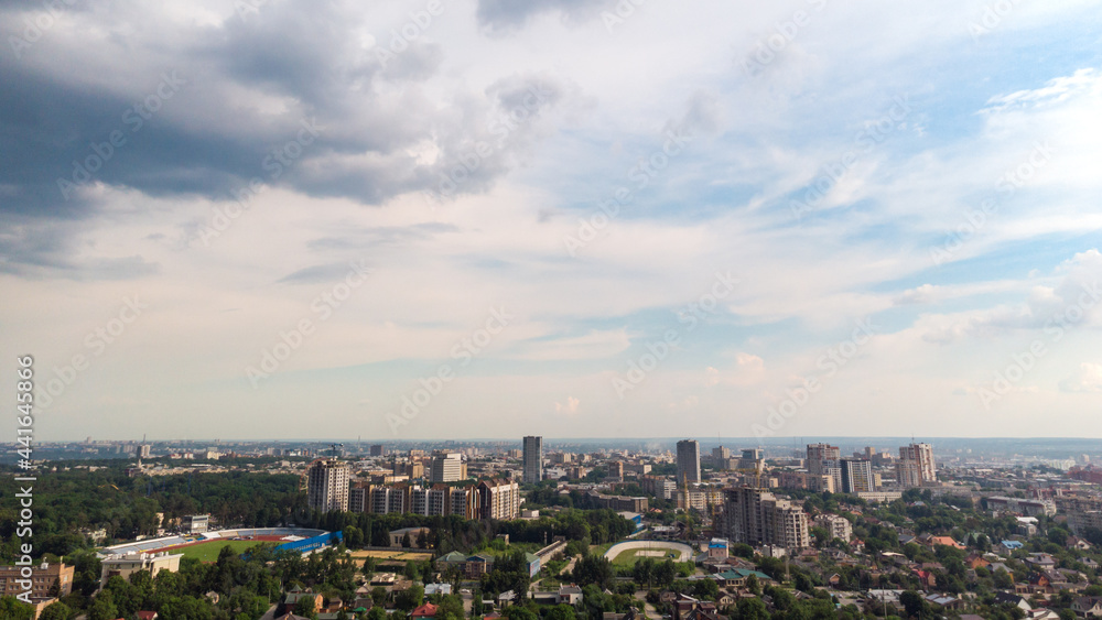Aerial panoramic cityscape view on green summer Kharkiv city center, stadiums, parks. Multistory modern high residential buildings on bright sunny day