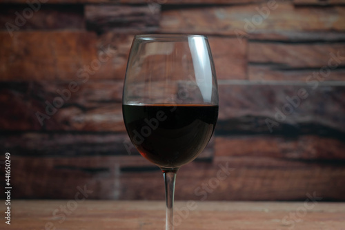 close-up shot of a glass of wine in a vineyard cellar