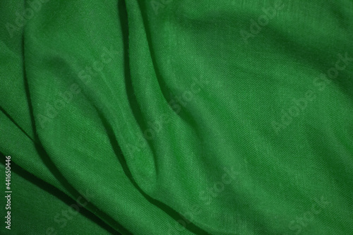 Green cotton fabric, soft and wavy.