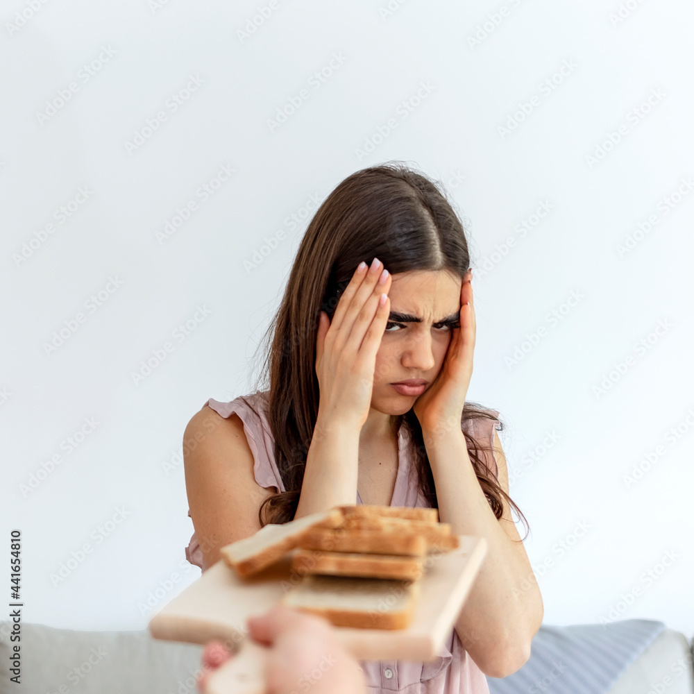 Cropped shot of a young woman on a gluten free diet is saying no thanks