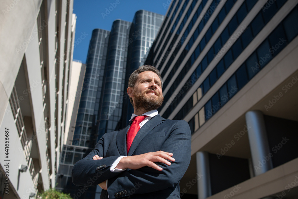 Portrait of businessman in front of modern office. Portrait of businessman in front of modern office.