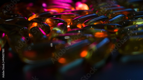 capsules on a dark surface