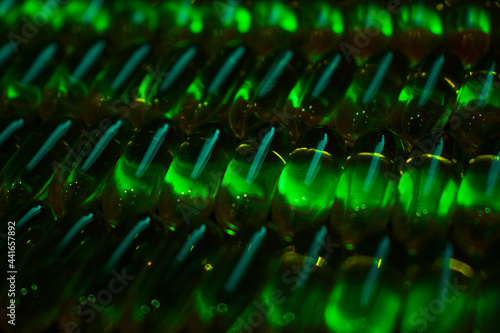 green capsules under darkness lighting